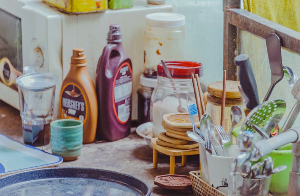 A well-equipped kitchen counter with utensils, jars, and condiment bottles.