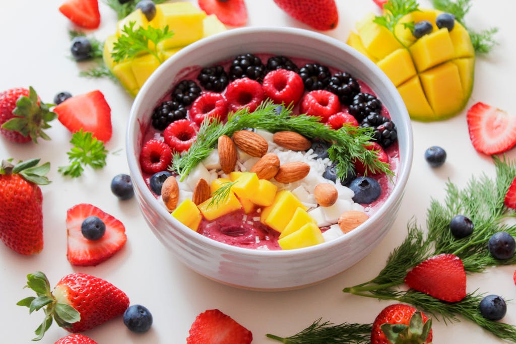 Colorful smoothie bowl with fresh fruits and almonds, perfect for a healthy breakfast.
