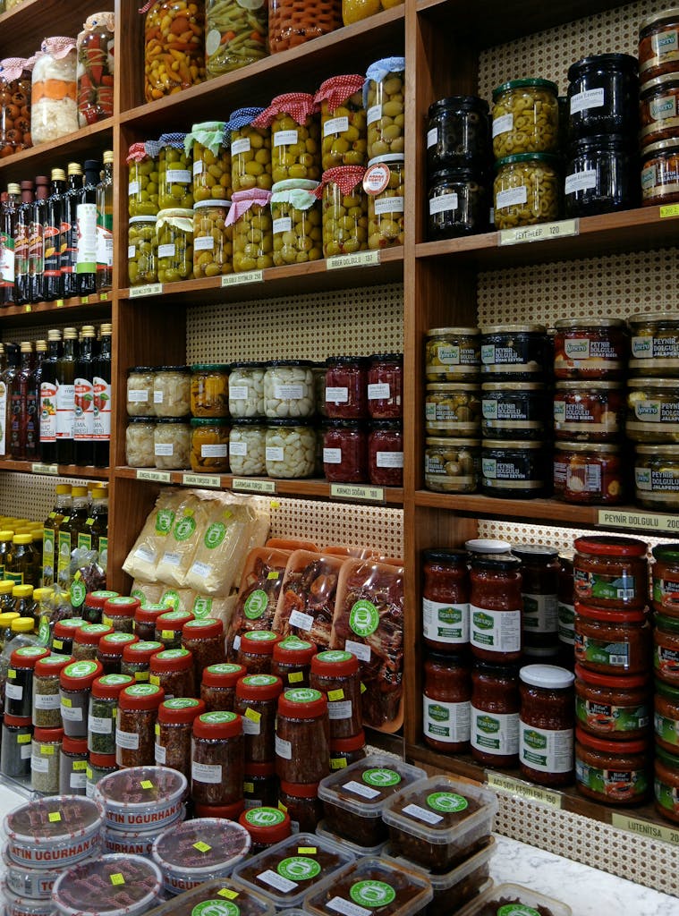 Colorful display of preserved food jars, a vibrant showcase in a grocery store aisle.
